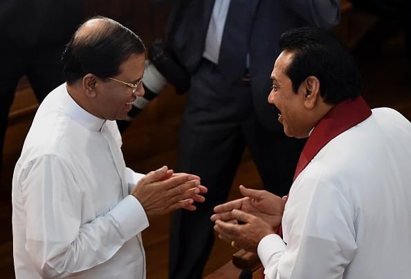 Sri Lankan President Maithripala Sirisena (L) 
talks with former president Mahinda Rajapakse .        (Photo credit 
should read Ishara S.KODIKARA/AFP/Getty Images)