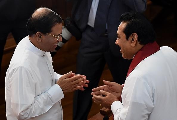 Sri Lankan President Maithripala Sirisena (L) 
talks with former president Mahinda Rajapakse .        (Photo credit 
should read Ishara S.KODIKARA/AFP/Getty Images)

