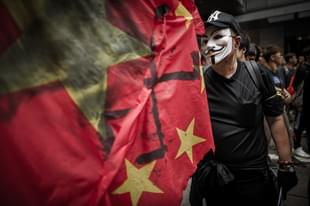 A man wears a mask of an anonymous hacker. (Photo Credit: PHILIPPE 
LOPEZ/AFP/GettyImages)