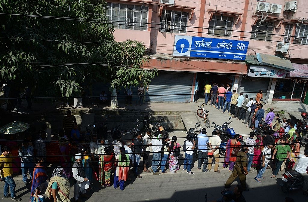 

Indian customers line up next to an ATM at a bank in Siliguri: Photo credit: DIPTENDU DUTTA/AFP/GettyImages