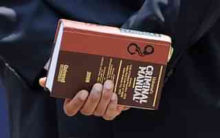A lawyer holds a criminal manual (INDRANIL MUKHERJEE/AFP/Getty Images)