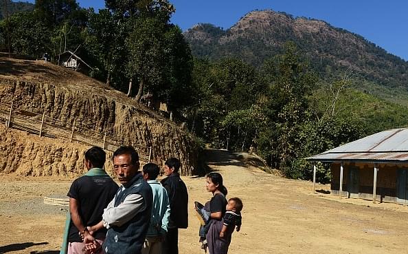 Manipur residents stand near a
mountain in Tamenglong around 80 km west of Imphal. Photo credit:DIBYANGSHU SARKAR/AFP/GettyImages
