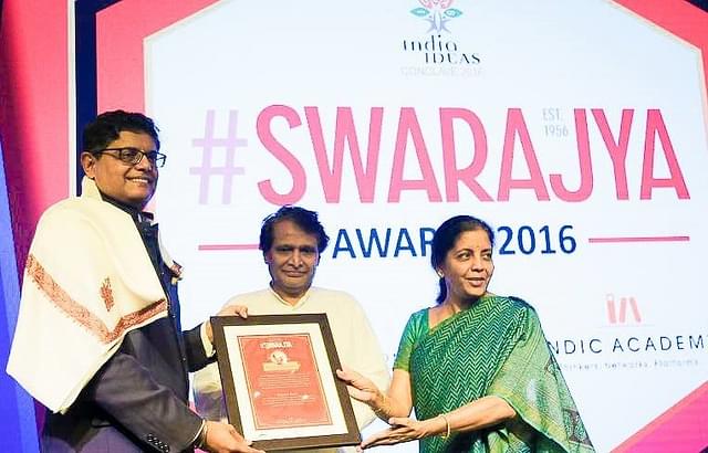 Jay Panda receiving the plaque from Union Railway Minister Suresh Prabhu and Minister of State for ministries of commerce &amp; industry and finance &amp; corporate affairs, Nirmala Sitharaman