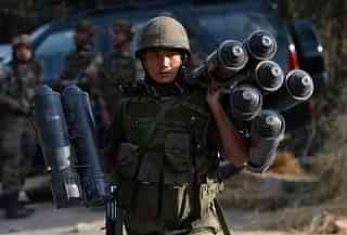 An Indian soldier carries ammunition.&nbsp;