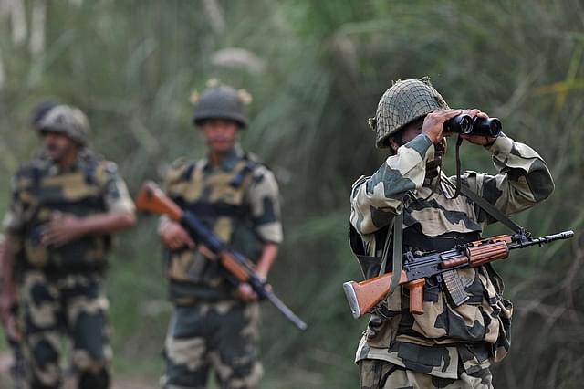 An Indian Border Security Force soldier looks through binoculars towards Pakistan. (TAUSEEF MUSTAFA/AFP/Getty Images)