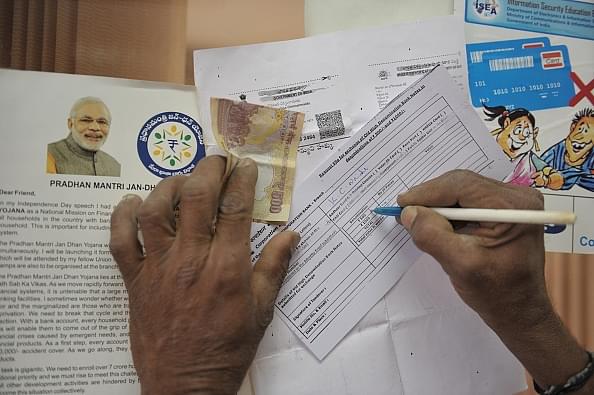 

A customer  fills out a form to exchange old denominations of money at a government bank in Medak district,  Hyderabad. Photo credit: NOAH SEELAM/AFP/GettyImages