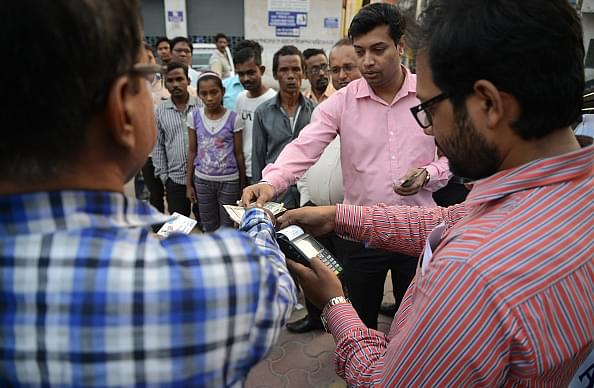 State Bank of India bank
staff assist customers to withdraw money with the use of a mobile banking
machine at Siliguri District hospital in Siliguri on 22 November 2016. Photo
credit: DIPTENDU DUTTA/AFP/GettyImages