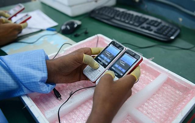 

An technician checks phones at a manufacturing facility in Rangareddy district on the outskirts of Hyderabad. Photo credit: NOAH SEELAM/AFP/GettyImages