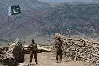 Pakistani soldiers keep vigil from a post on top of a mountain. (STR/AFP/Getty Images)