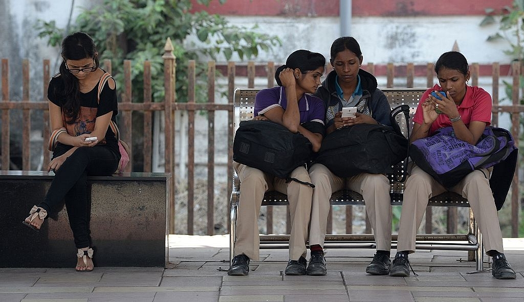 Indian women check their mobile telephones at a free Wi-Fi
Internet zone in Mumbai. Photo credit: INDRANIL MUKHERJEE/AFP/GettyImages &nbsp; &nbsp; &nbsp;