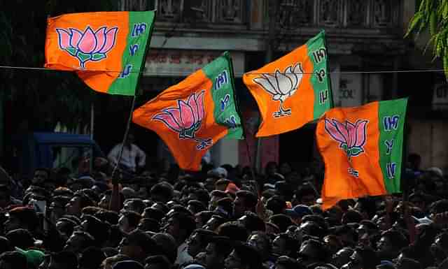 Supporters wave BJP flags. ( INDRANIL MUKHERJEE/AFP/Getty Images)