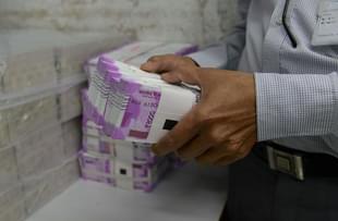 Representative image of stacks of cash (SAM PANTHAKY/AFP/Getty Images)