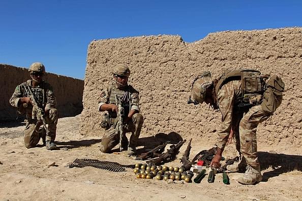 Afghan soldiers take position during a battle with Taliban militants. (GettyImages)