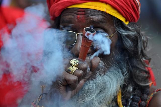 An Indian sadhu  puffs cannabis (BIJU BORO/AFP/Getty Images)