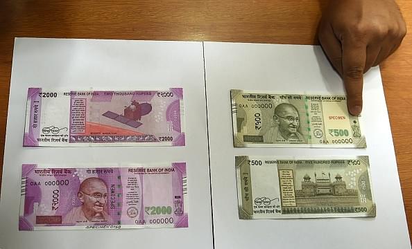 

Samples of the new Rs 500 and Rs 2,000  notes are displayed at the Reserve Bank of India  headquarters in Mumbai a day after the demonetisation announcement on 8 November. Photo credit: PUNIT PARANJPE/AFP/GettyImages