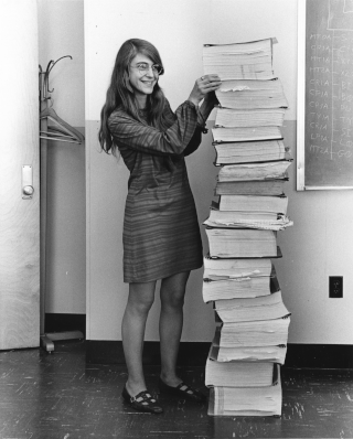 Margaret Hamilton standing next to the navigation software that she and her MIT team produced for the Apollo Project. (Source: Draper Laboratory)