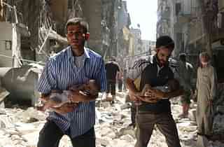 
Syrian men carrying babies make their way through the 
rubble of destroyed buildings following a reported air strike. (Photo Credit: AMEER ALHALBI/AFP/Getty Images)

