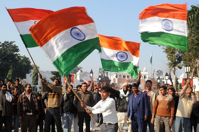 People waving the Indian flag. Image credit: NARINDER NANU/AFP/Getty Images