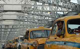 Indian taxi drivers sit in heavy traffic on Howrah Bridge in Kolkata (DIBYANGSHU SARKAR/AFP/Getty Images)