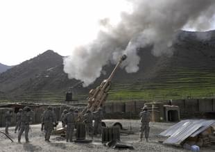 US soldiers fire shots using an M-777 howitzer. Photo credit: LIU JIN/AFP/GettyImages