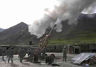 
US soldiers fire shots using an M-777 howitzer. Photo credit: LIU JIN/AFP/GettyImages

