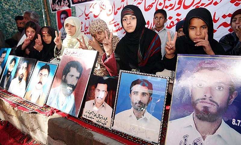 Families with photos of those killed by the Pakistan army. (Dawn.com)
