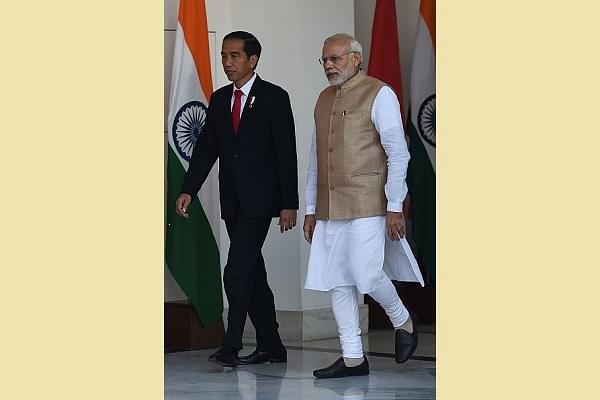 Prime Minister Narendra Modi (R) arrives with the Indonesia President Joko Widodo for a meeting at the Hyderabad House in New Delhi. (MONEY SHARMA/AFP/Getty Images)