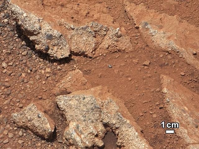 Captured by NASA’s Curiosity rover, a rock outcrop pops out from a Martian surface that is elsewhere blanketed by reddish-brown dust, showing evidence for an ancient, flowing stream. (NASA/JPL-Caltech/MSSS via Getty Images)
