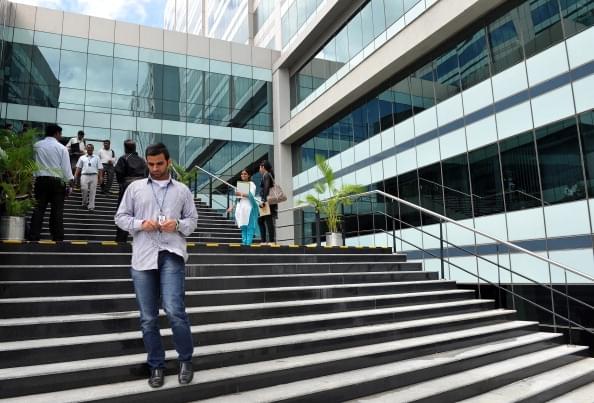 An employee of Wipro, India’s third largest software company, walks down the stairs at the campus of the software giant in Bangalore. (Manjunath Kiran/AFP/GettyImages)