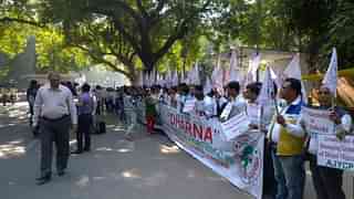 Activists in New Delhi hold banners against the proposal to grant citizenship to Hindu Bangladeshis.&nbsp;