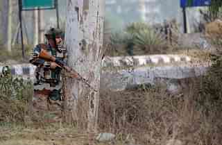 An Indian army soldier stands guard during a gun battle with armed militants at an Indian army base at Nagrota,  Jammu. Photo credit: STRINGER/AFP/Getty Images
