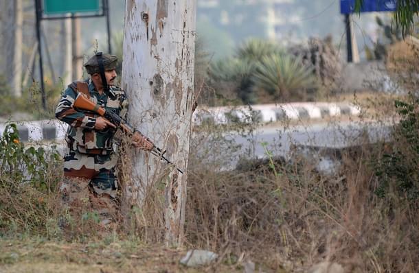 Indian army soldier stands guard during a gun battle. (STRINGER/AFP/Getty Images)