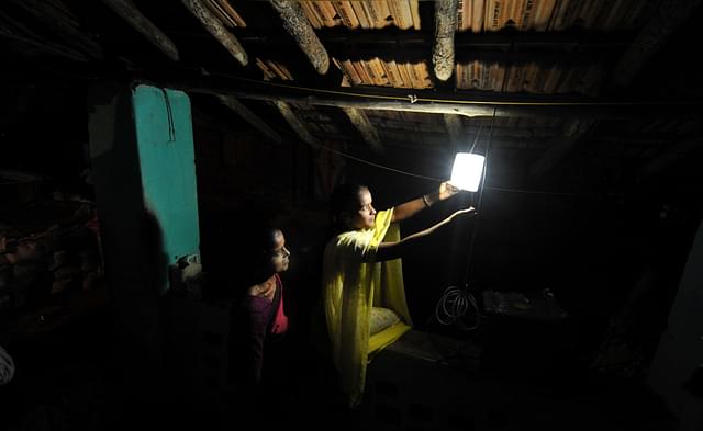 Villagers switch on a light in Morabandar, Elephanta Island, off the coast of Mumbai. (SAJJAD HUSSAIN/AFP/Getty Images)&nbsp;