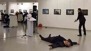 Karlov lies on the floor
next to his killer an art
exhibition in Ankara. (STRINGER/AFP/GettyImages)