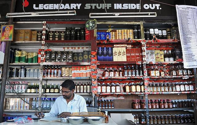 
An Indian employee writes down stock at an alcohol store in 
Hyderabad. (NOAH
 SEELAM/AFP/Getty Images)

