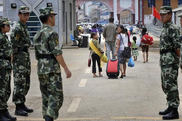 File picture: Chinese soldiers stand guard as refugees cross the border towards 
Myanmar on 31 August 31, 2009. Photo 
credit: PHILIPPE LOPEZ/AFP/GettyImages