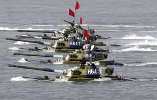 Amphibious tanks of the Chinese People’s Liberation Army move to land a beach. (China Photos/Getty Images)