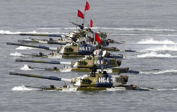 Amphibious tanks of the Chinese People’s Liberation Army move to land a beach. (China Photos/Getty Images)