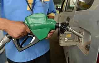 A fuel pump employee fills
a car with petrol at a service station in New Delhi.