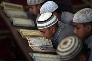 Students of a madrassa recite the Quran at their seminary. Photo credit: AAMIR QURESHI/AFP/GettyImages