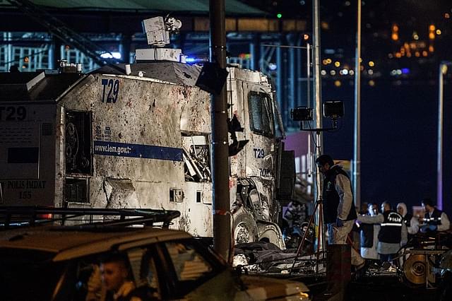 Turkish forensic police officers work at the site where a car bomb exploded near the stadium of football club Besiktas in central Istanbul. (OZAN KOSE/AFP/Getty Images)