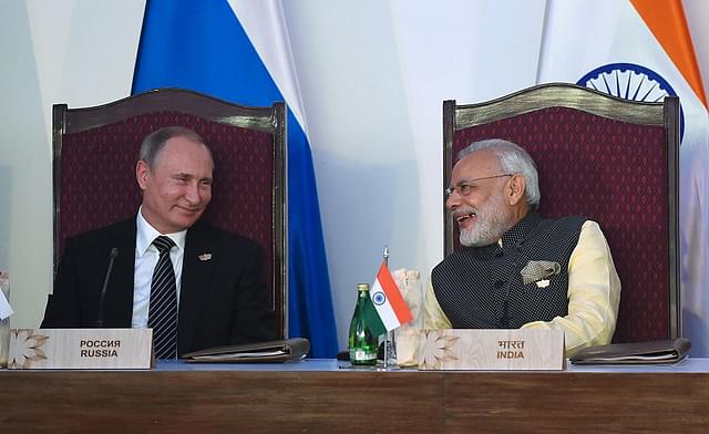 Prime Minister Narendra Modi smiles while talking with 
Russia’s President Vladimir Putin. (PRAKASH
 SINGH/AFP/Getty Images)

