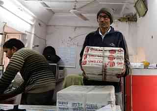 
Indian postman Ratan Lal 
with a parcel. Photo
 credit: SAJJAD HUSSAIN/AFP/GettyImages

