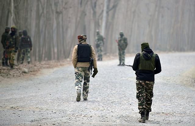Indian paramilitary troopers stand guard near the site of a gunbattle between suspected militants and Indian security personnel at Arwani Bijbehara, south of Srinagar, Kashmir. (TAUSEEF MUSTAFA/AFP/Getty Images) 