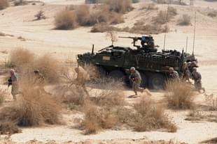 Indian and US soldiers exit an infantry combat vehicle during joint military exercise at Mahajan in Rajasthan sector, some 150 kms. from Bikaner. Photo credit: SAM PANTHAKY/AFP/GettyImages