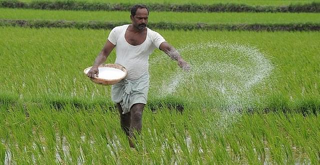 A farmer fertilises his field. (GettyImages)