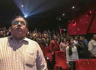 Audience members stand for the Indian national anthem before a movie starts at a cinema in New Delhi. (CHANDAN KHANNA/AFP/Getty Images)