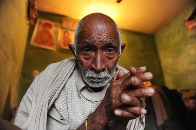 

 Hindu refugee from West Pakistan, Mangu Ram (82) sits inside his concrete shanty in Surej Chak, on the outskirts of Jammu. (TAUSEEF MUSTAFA/AFP/Getty Images)