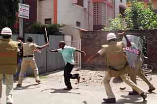 Bihar policemen baton-charge a demonstrator  in Chhapra. (STR/AFP/Getty Images)