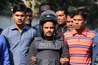 Bangladesh Police escort alleged Islamist militant Jahangir Alam (C) in Dhaka after his arrest in connection with an attack on the Holey Artisan Bakery attack last year. (STR/AFP/Getty Images)